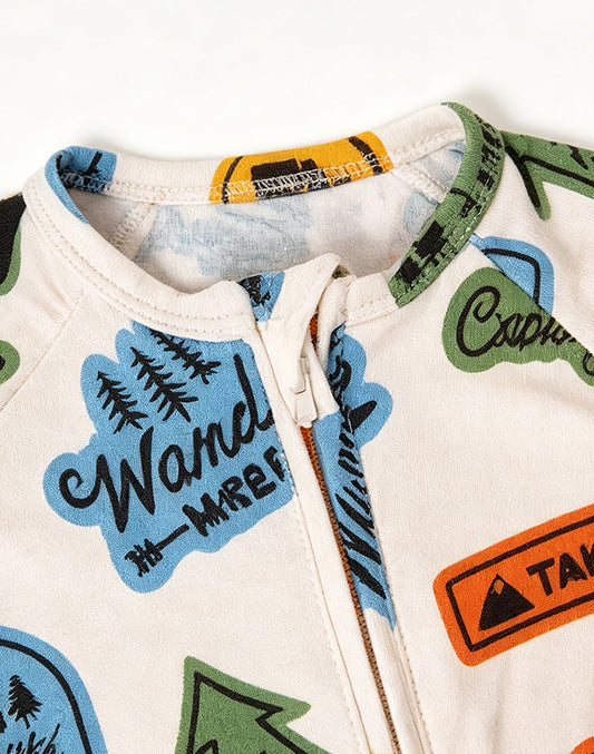 Close-up of bamboo viscose baby footed zip sleepsuit neckline and zipper with adventure badge print - MUHONG APPAREL