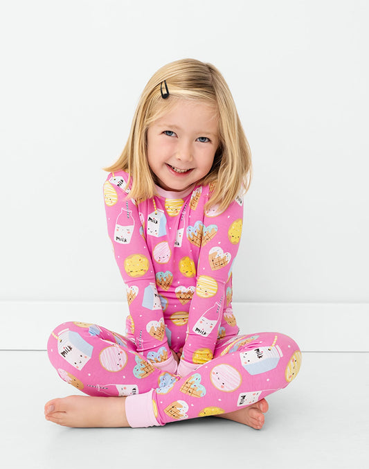 Girl sitting wearing pink milk and cookies print matching pajama set - MUHONG APPAREL