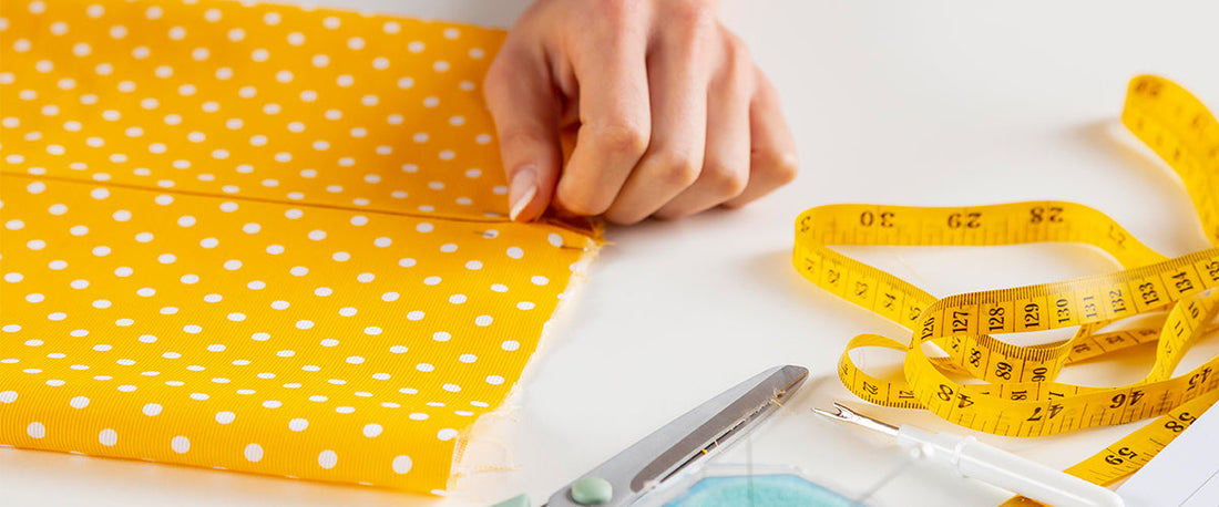 Kids clothing size chart and folded garments on a factory measuring table