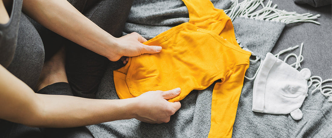 snug-fitting baby sleepwear flat lay showing tapered cuffs and seam construction