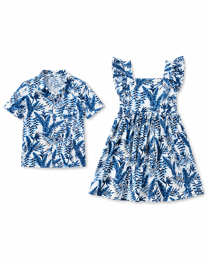 Sibling matching tropical blue palm leaf set boy shirt and girl dress flat lay - Alice Apparel