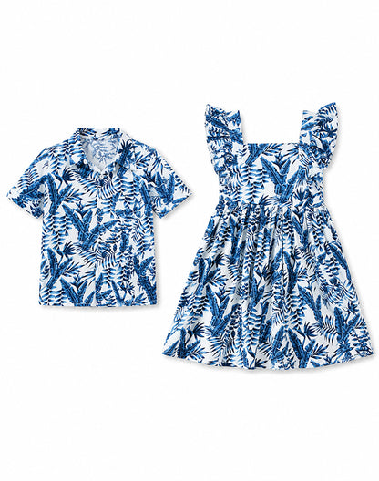 Sibling matching tropical blue palm leaf set boy shirt and girl dress flat lay - Alice Apparel