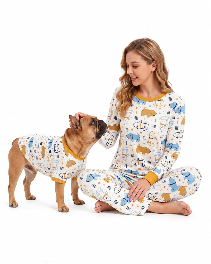 Woman and dog wearing matching playful print pajamas