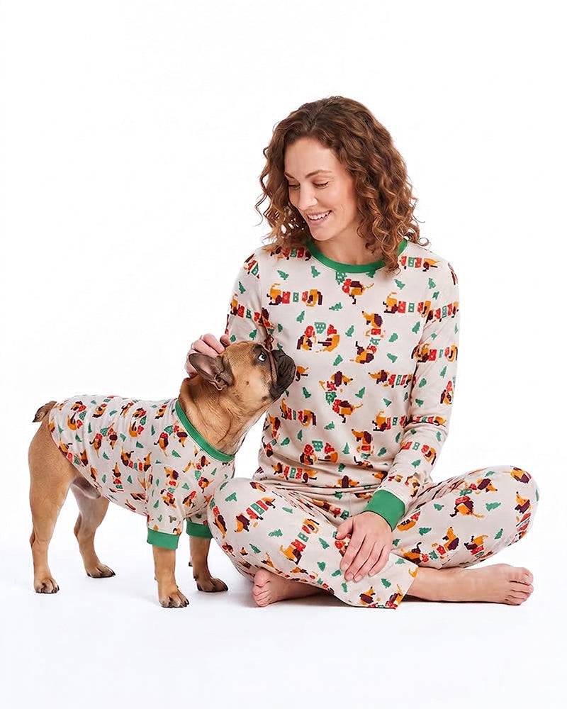 Woman and dog wearing matching cartoon print pajamas