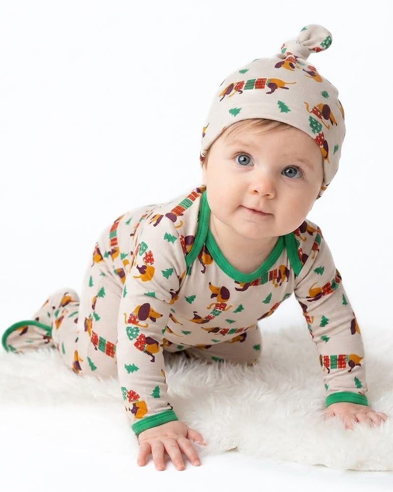 Baby wearing cartoon print long sleeve pajama set with matching hat
