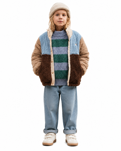Girl wearing a color block sherpa fleece jacket with a stand collar and front pockets