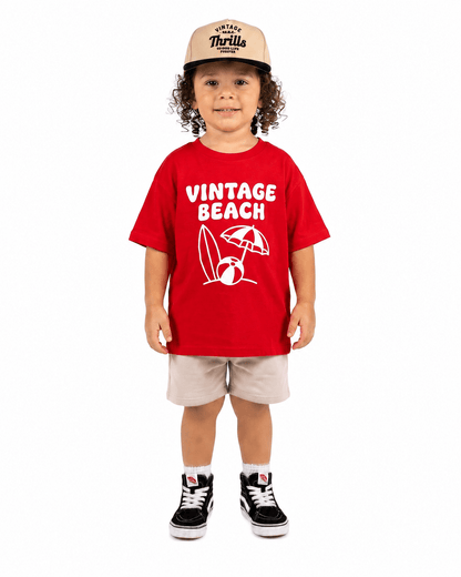 Boy wearing red Vintage Beach graphic T-shirt
