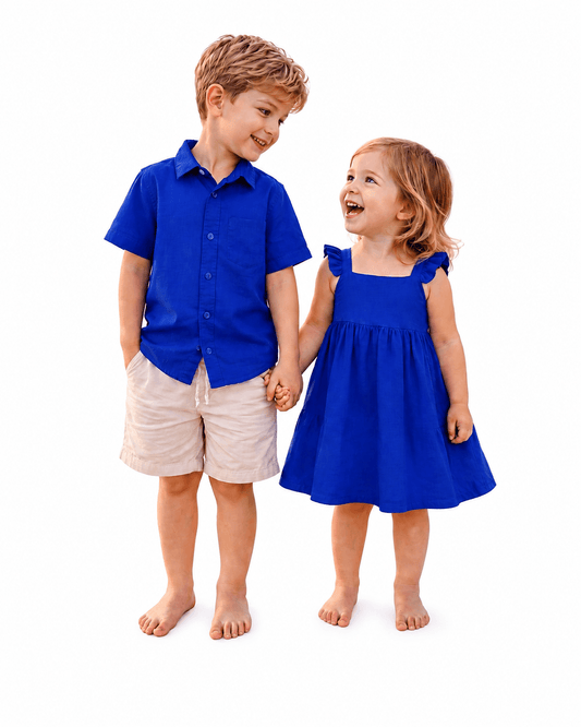 Boy and girl wearing blue sibling matching shirt and dress outfits