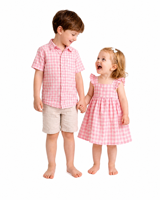 Boy and girl wearing pink gingham sibling matching shirt and dress outfits