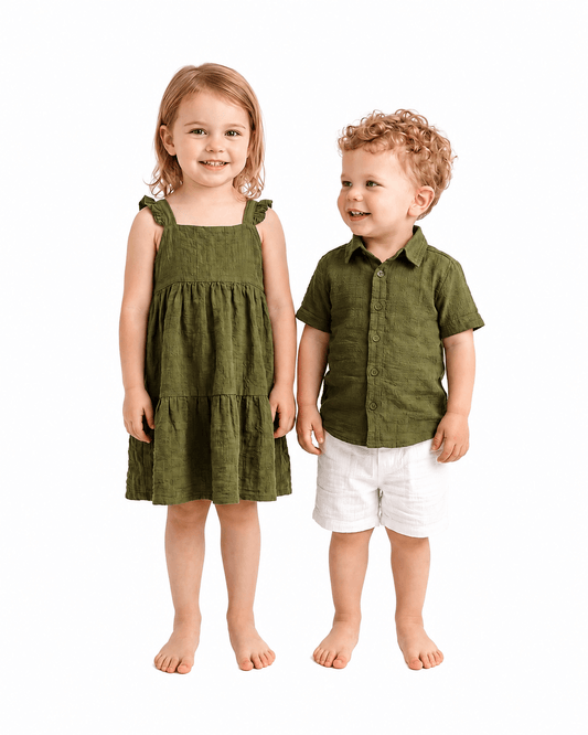 Boy and girl wearing olive green sibling matching shirt and ruffle dress