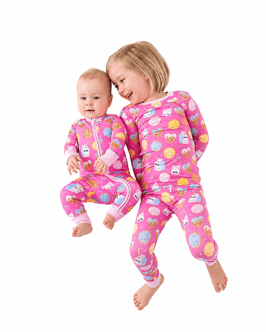 Children wearing pink sibling matching pajamas and baby romper