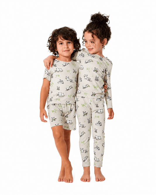 Children wearing matching printed short and long pajama sets