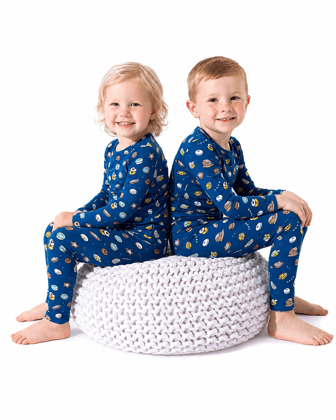 Children wearing blue sibling matching long sleeve pajama sets