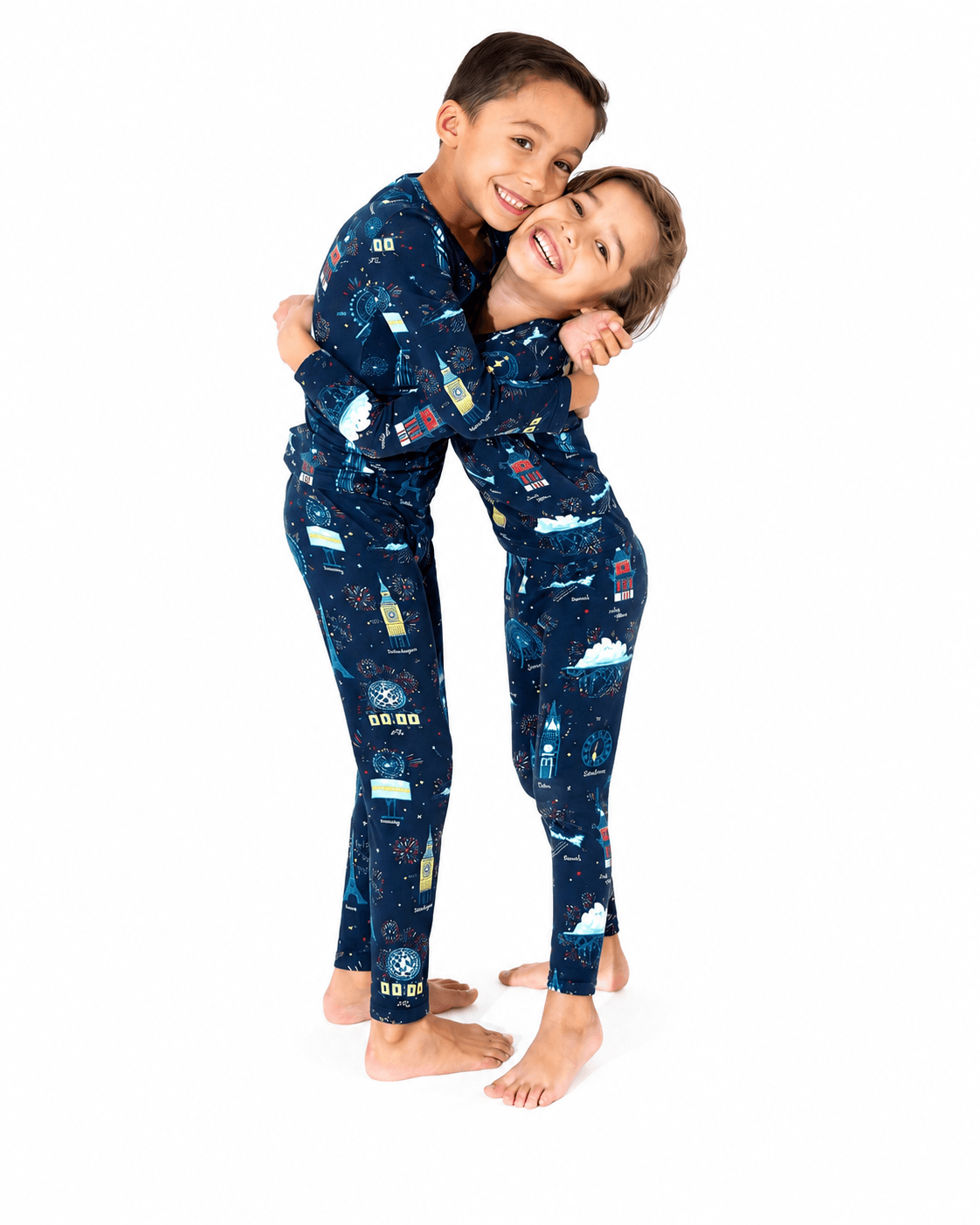 Children wearing navy space print sibling matching long sleeve pajamas