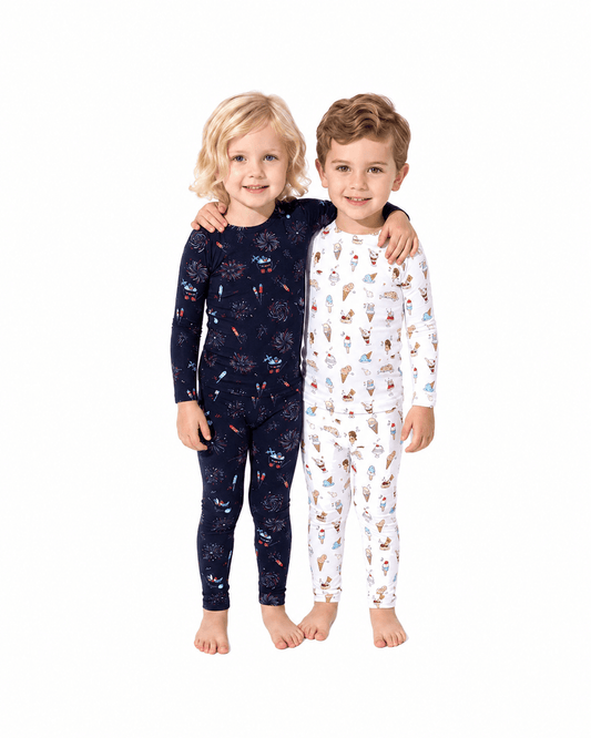 Children wearing navy and white printed sibling matching pajama sets