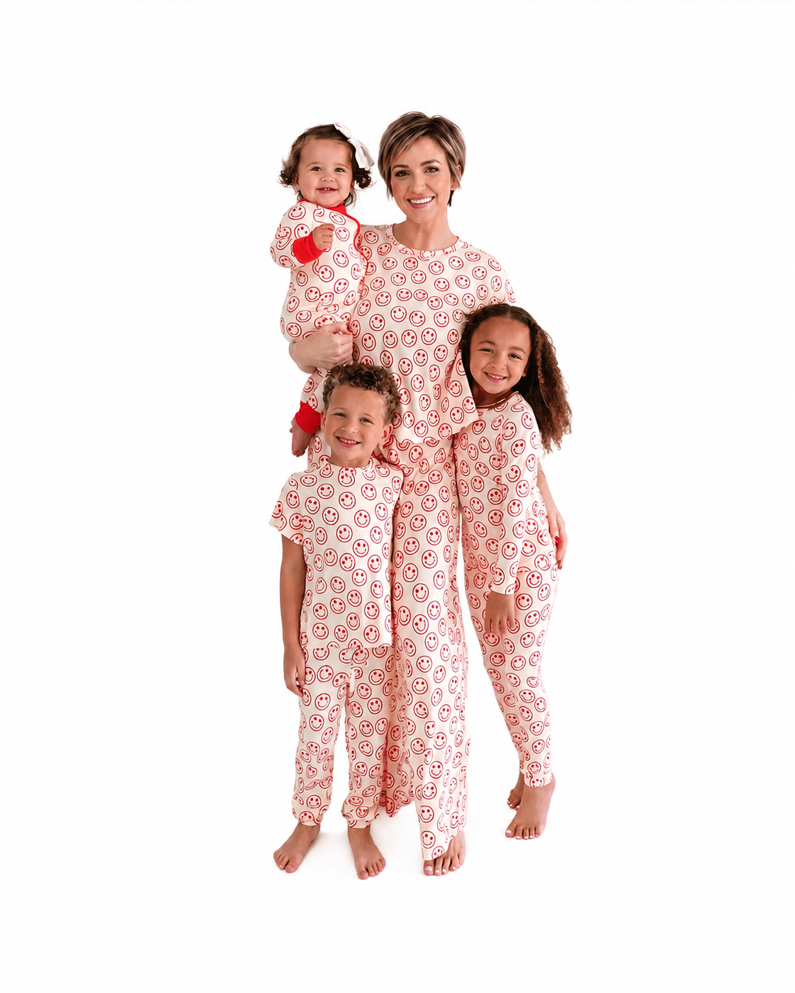 Family wearing pink floral matching pajamas in adult kids and baby styles