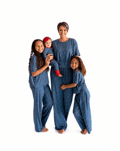 Family wearing navy printed matching pajamas in adult kids and baby styles