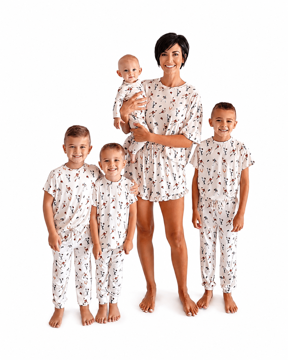 Family wearing cream printed matching pajamas in adult kids and baby styles