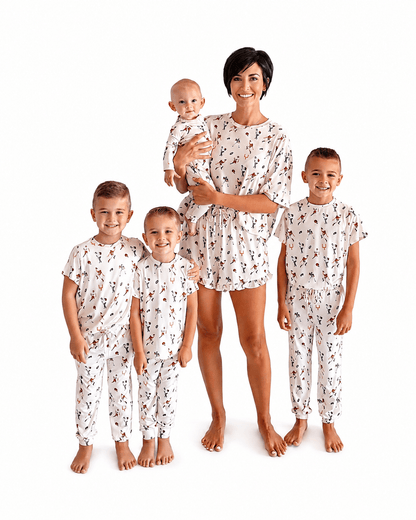 Family wearing cream printed matching pajamas in adult kids and baby styles