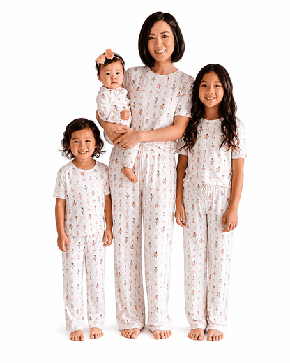 Family wearing ivory printed matching pajamas in adult kids and baby styles