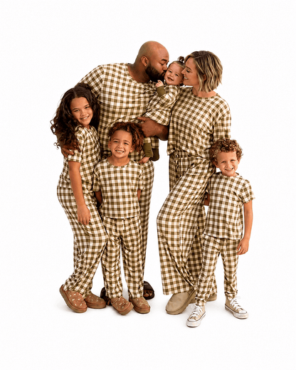 Family wearing brown gingham matching pajamas in adult kids and baby styles