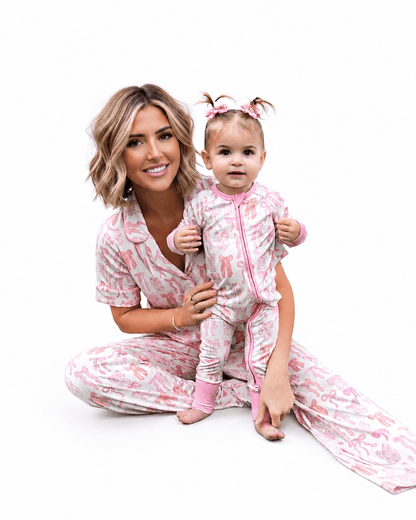 Mother and baby wearing pink printed matching pajamas