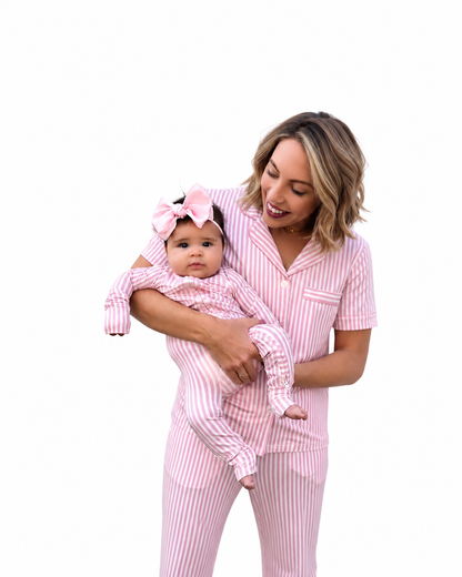Mother and baby wearing pink striped matching pajamas