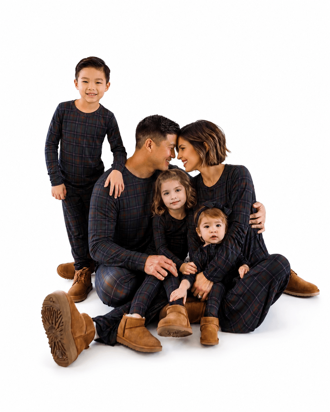 Family wearing navy plaid matching long sleeve pajamas