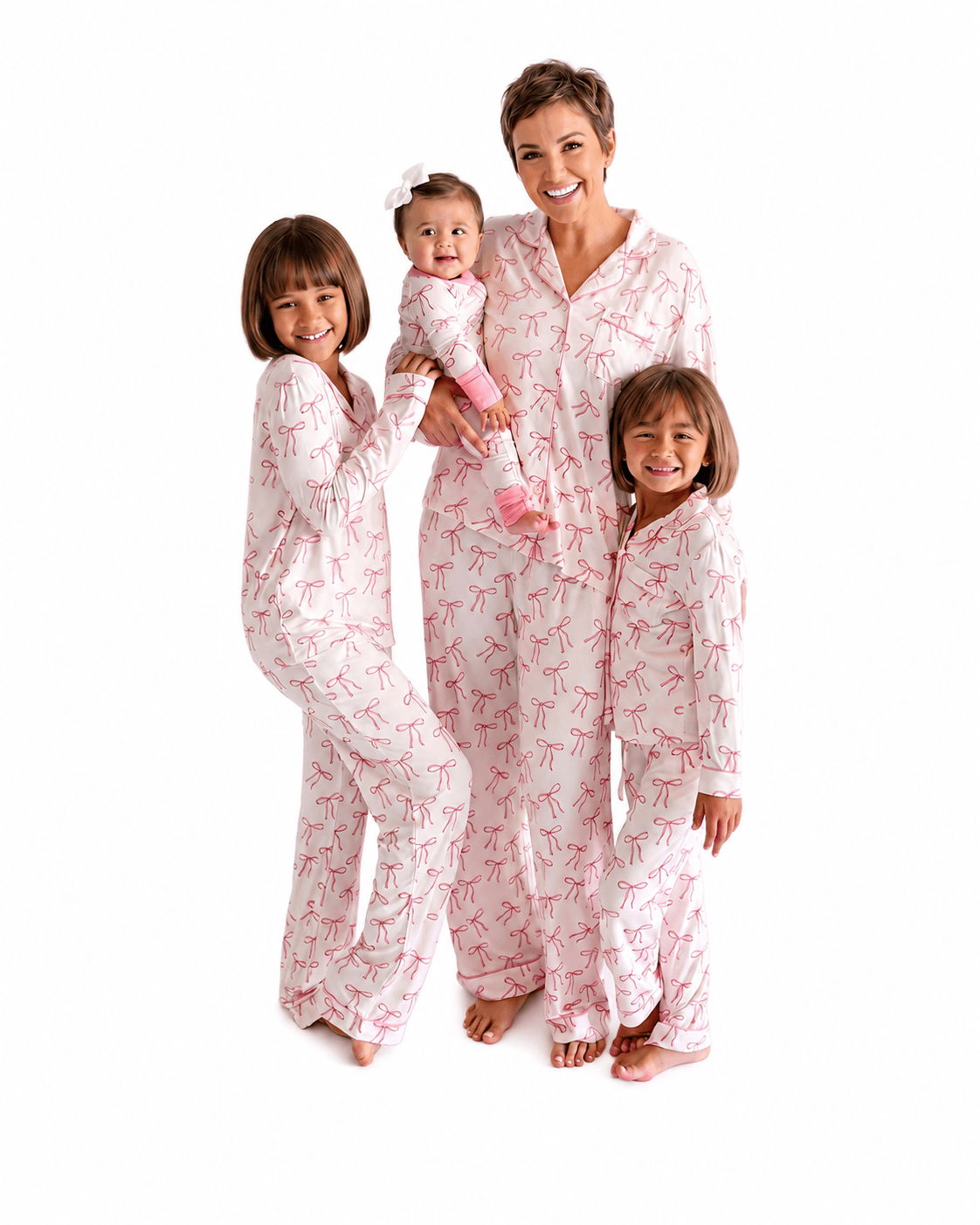 Blush pink bow print matching family pajamas for woman, girls, and baby
