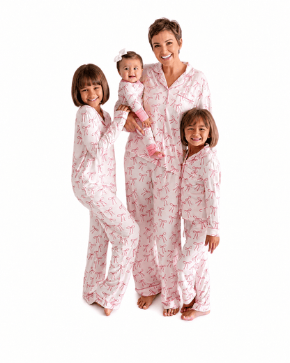 Blush pink bow print matching family pajamas for woman, girls, and baby