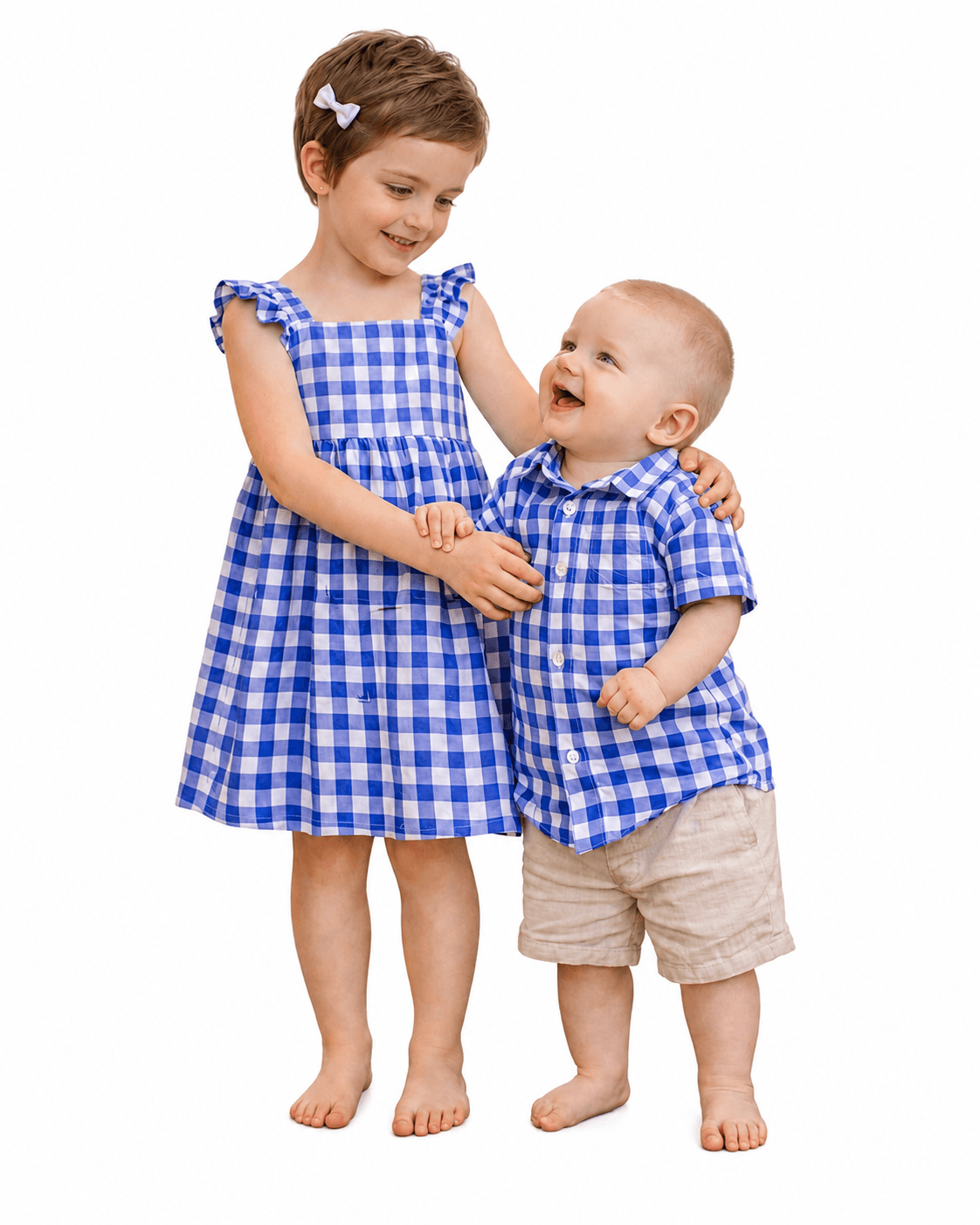 Girl and toddler boy wearing blue gingham brother and sister matching outfits