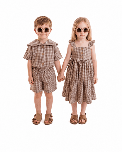 Boy and girl wearing brown gingham sibling matching outfits