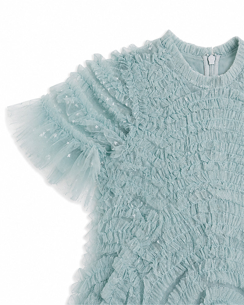 Close-up of the textured fabric and layered tulle sleeve on a girls light blue party dress