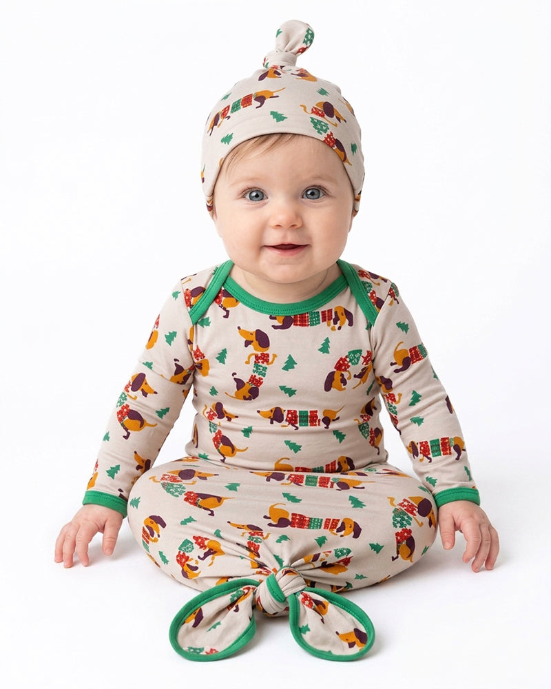 Baby wearing matching cartoon print pajama set and printed hat
