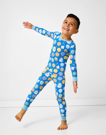 Boy wearing blue milk and cookies print matching pajama set posing - Alice Apparel