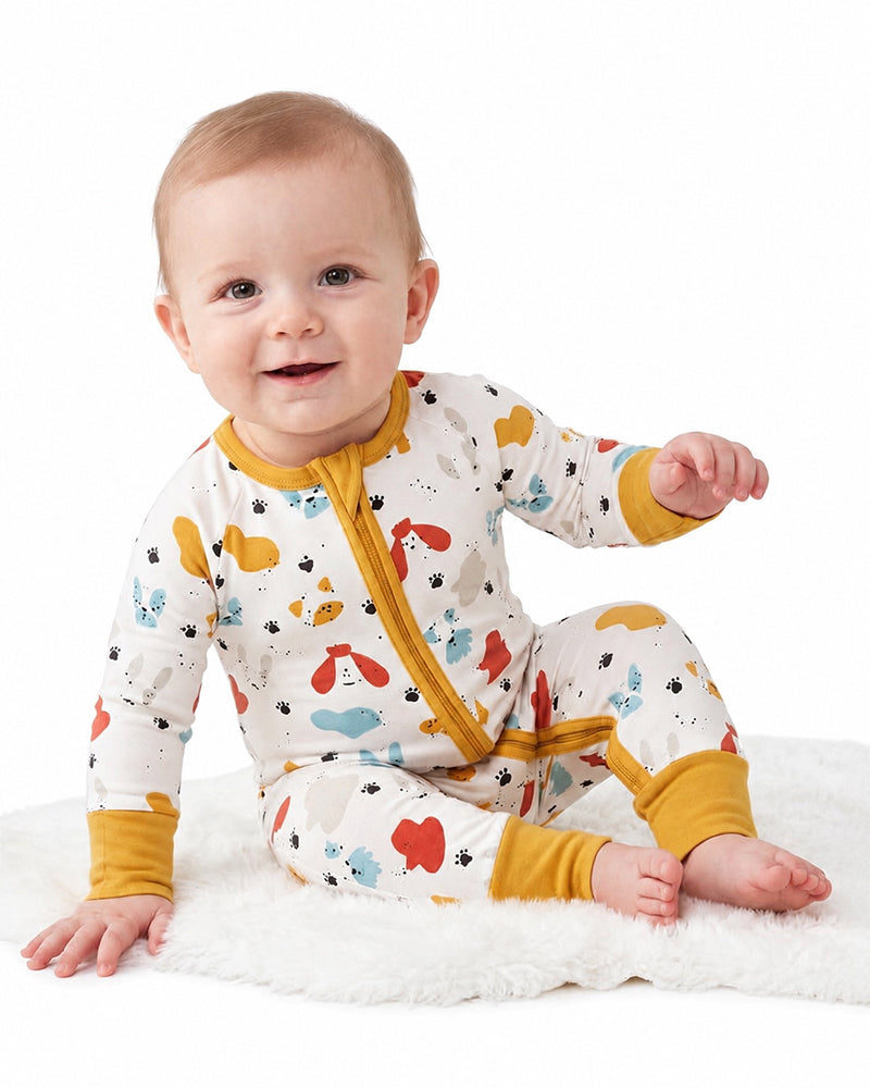 Baby sitting in farm animal print zipper pajama romper
