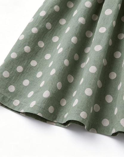 Close-up of sage green polka dot dress fabric detail - Alice Apparel