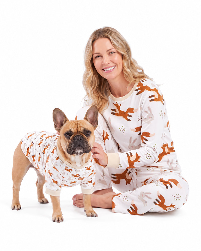 Woman wearing matching dog pajama set for family pet sleepwear collection