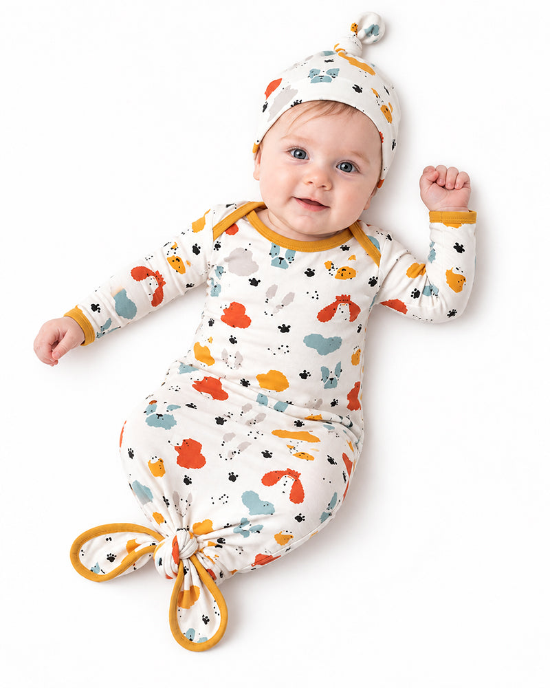 Baby wearing animal print knotted gown with matching knot hat