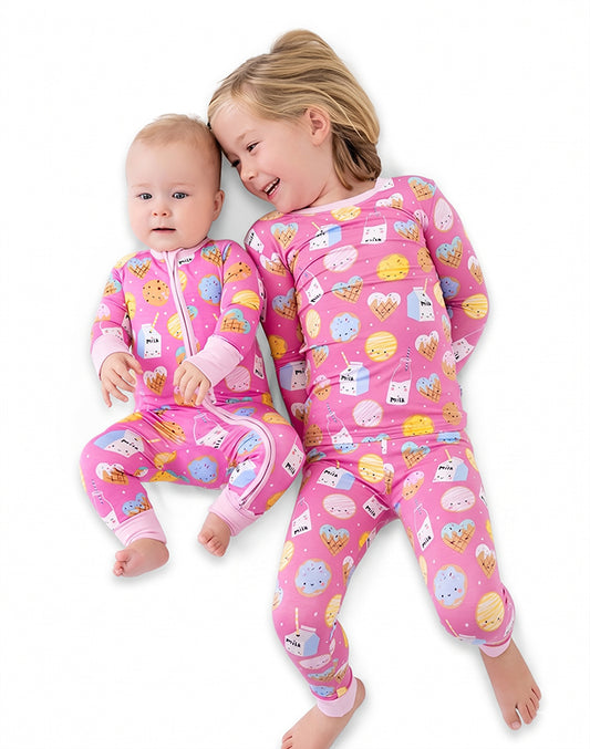 Baby girl and big sister wearing pink milk and cookies matching pajama set lying down - Alice Apparel