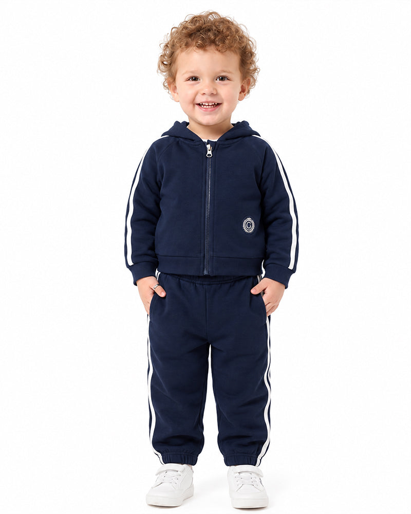 Child wearing custom navy zip-up hooded tracksuit set