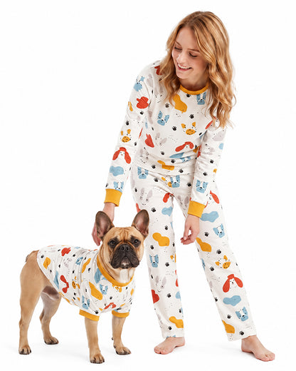 Woman and dog wearing matching animal print pajamas