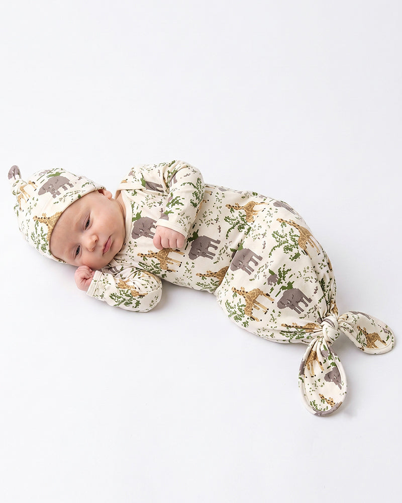 Newborn wearing woodland print knotted gown and matching hat