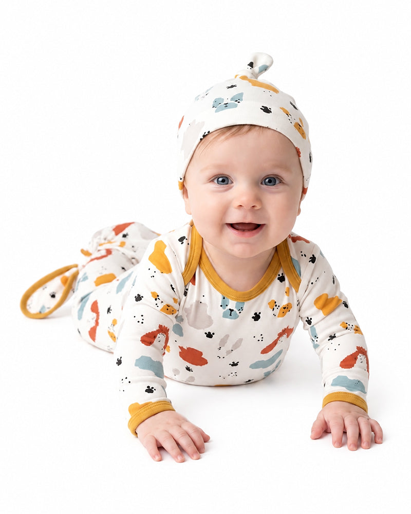 Baby wearing matching animal print knotted gown and hat