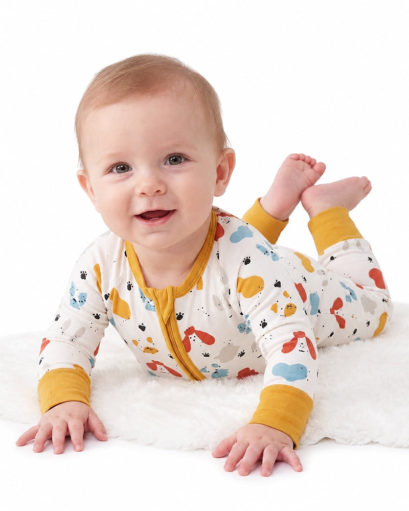 Baby wearing farm animal print zip-up pajama romper