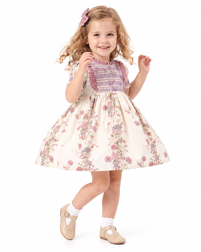 Girl wearing floral smocked ruffle sleeve dress
