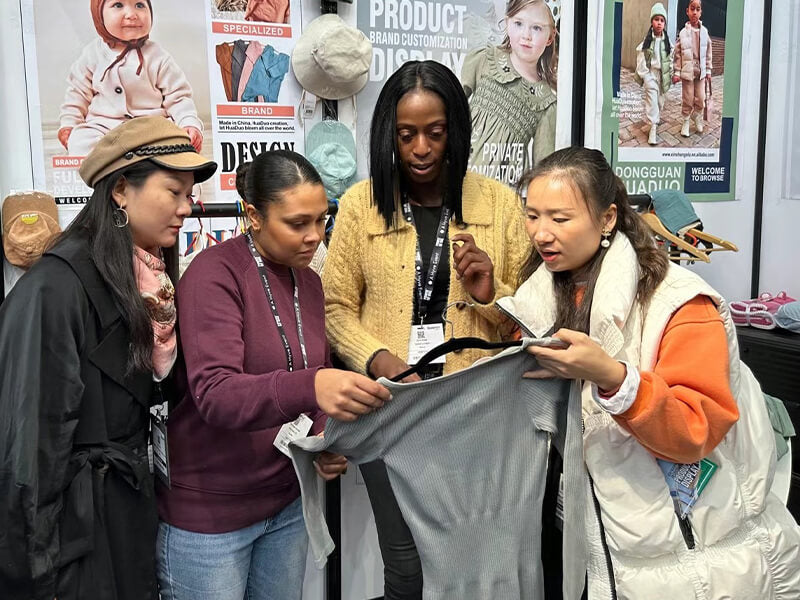Buyer visiting Alice Apparel showroom for baby clothing sample review