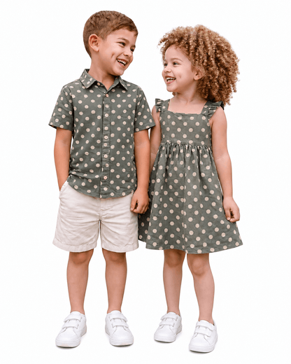 Boy and girl wearing sage green polka dot sibling matching outfits