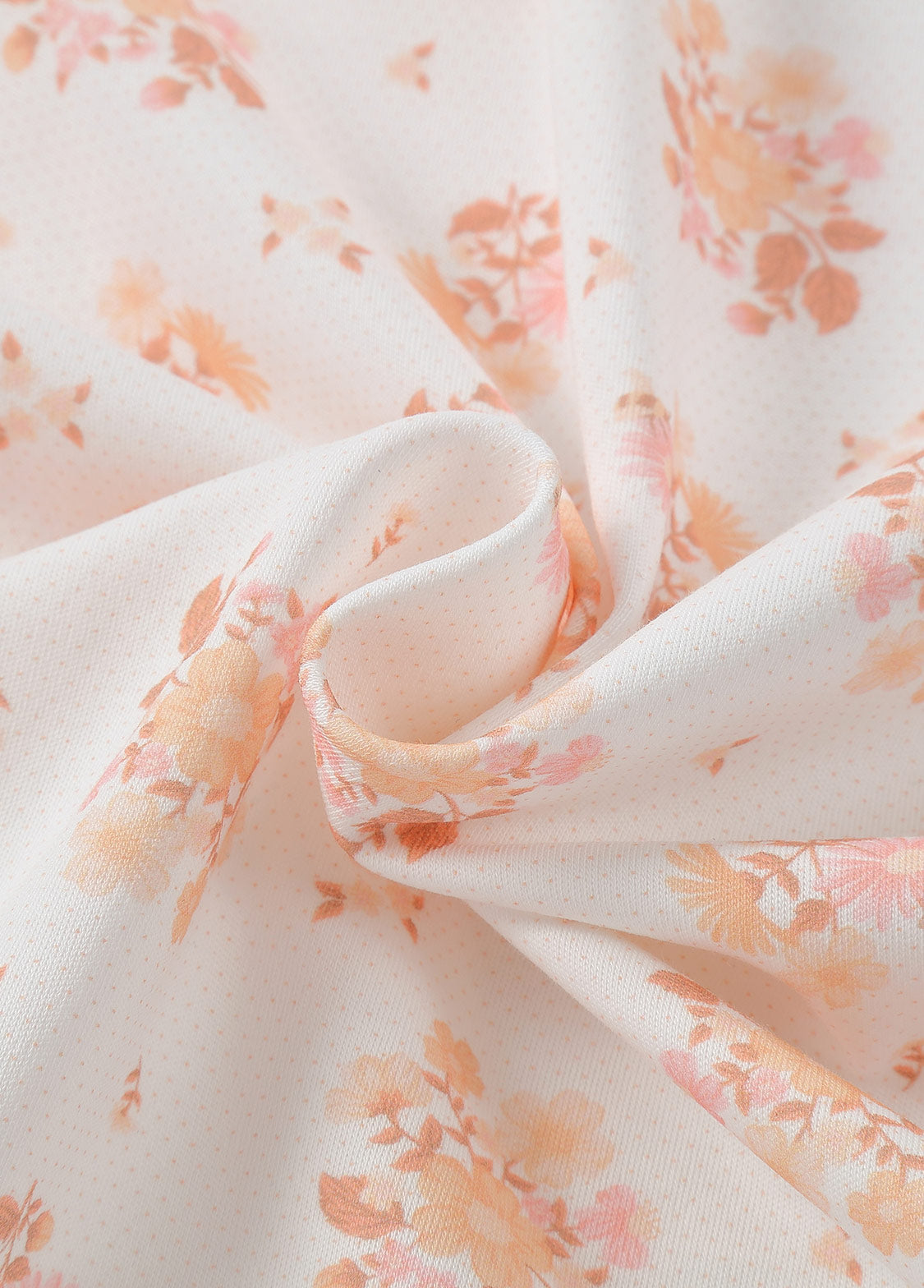 Close-up of soft cotton stretch fabric used for a floral baby swaddle blanket