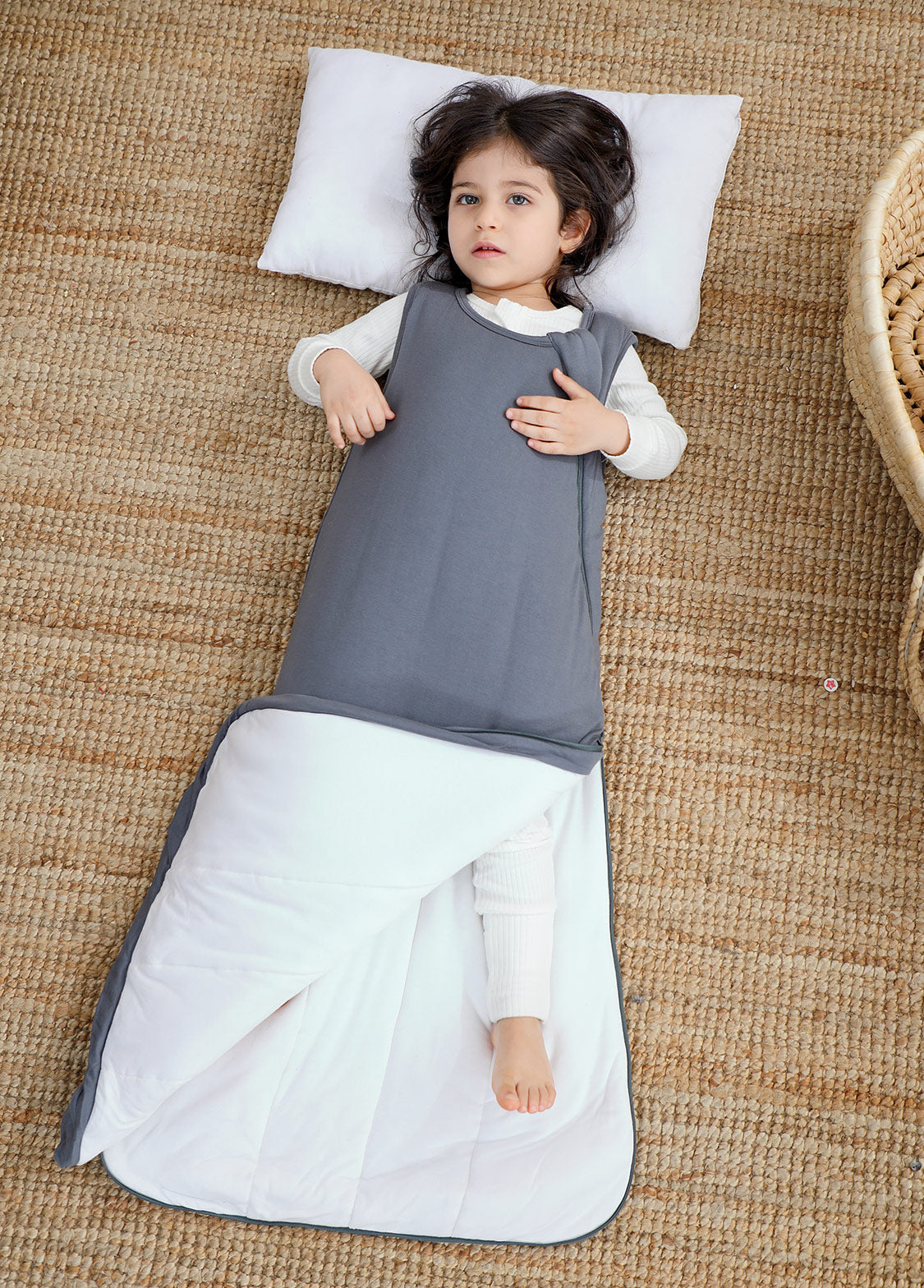 Baby in a gray cotton sleep sack showing the roomy lower-body design